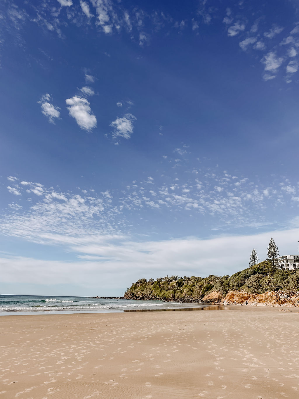 Coolum Beach shoreline with wide open sand and sky